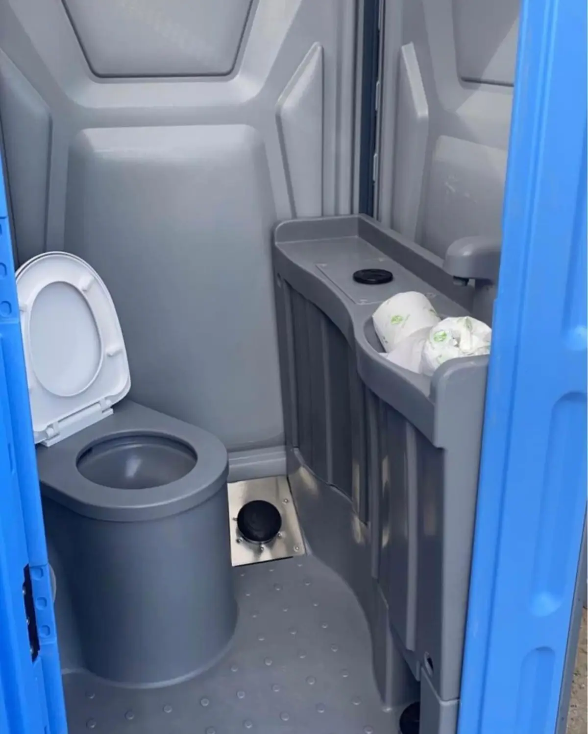 Deluxe porta potty interior with seat and sink counter