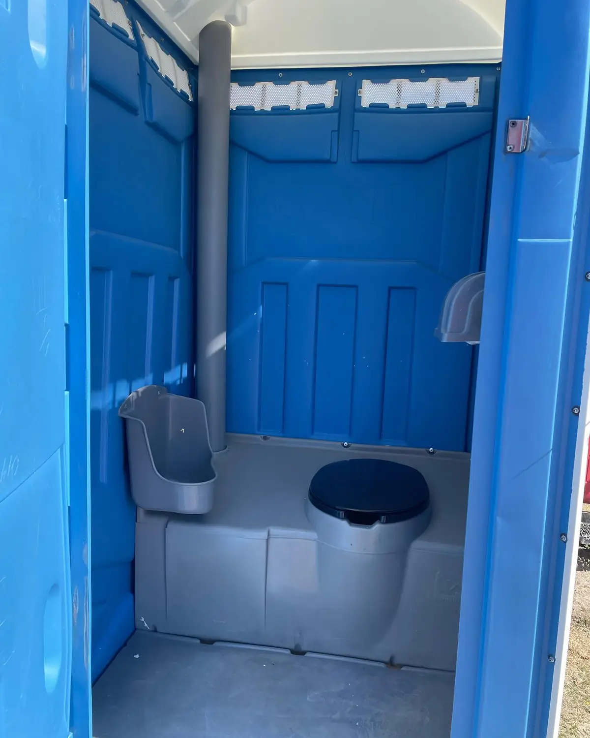 Urinal and seat inside a standard portable toilet