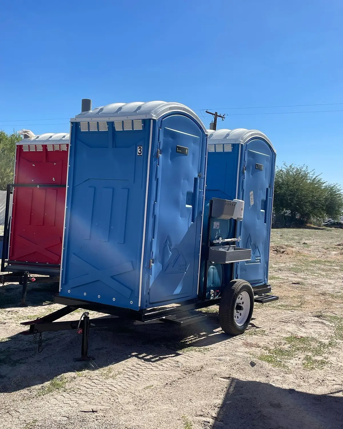Porta potty mounted on a small towable trailer